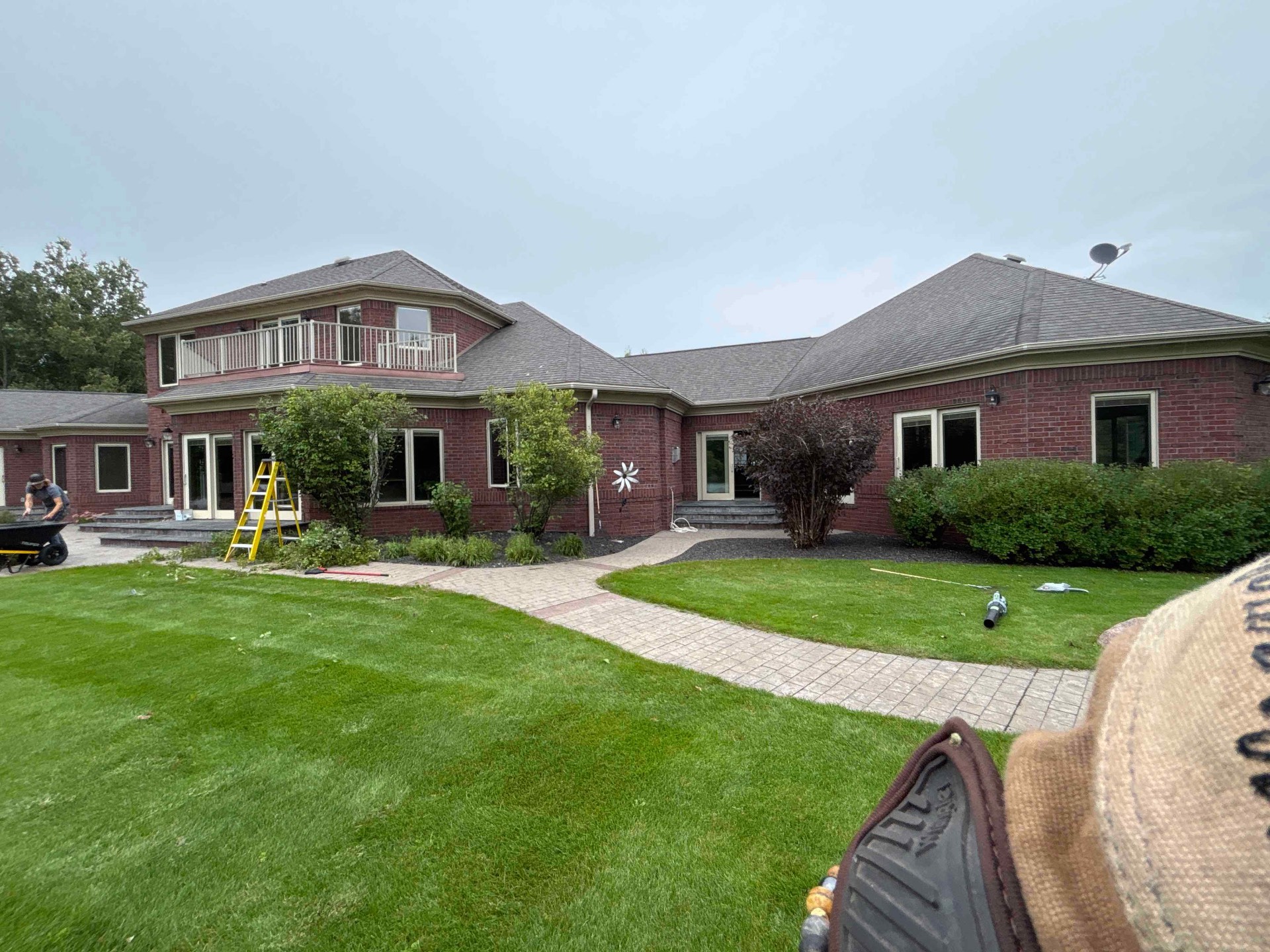 No Plan LLC crew completing landscape-bed installation around a Central Wisconsin residence